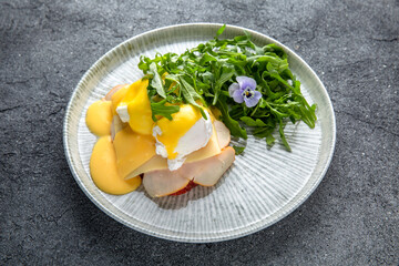 Sandwich with ham, cheese and herbs. Hearty, nutritious breakfast. Ready menu for the restaurant. Neutral gray blue textured background