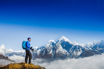 Naklejka na ściany i meble Hiker on the top in Himalayas mountains. Travel sport lifestyle concept