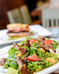 Salad with beef, tomatoes, fresh lettuce salad and arugula, raw mushrooms and great dressing from dijon mustard.