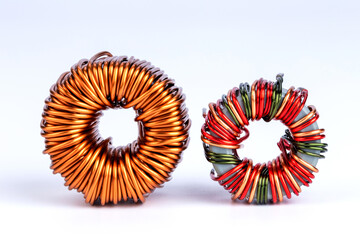 Inductor coils, copper wire coil, toroid, isolated on white background.