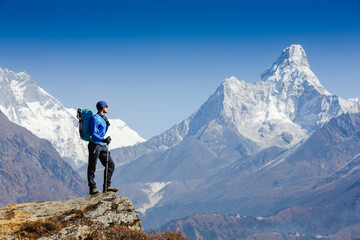 Fototapeta premium Hiker enjoying the view on the Everest trek in Himalayas, Ama Dablam mountain view, Nepal