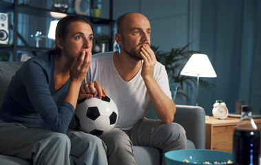 Soccer fans watching the match on TV