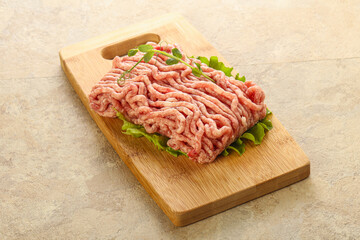 Raw minced pork meat over board