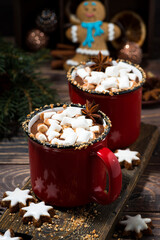 cozy winter drink hot chocolate in red mugs on wooden table, top view
