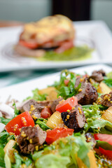 Salad with beef, tomatoes, fresh lettuce salad and arugula, raw mushrooms and great dressing from dijon mustard.