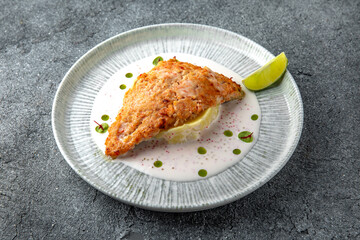 Chicken chop in batter with mashed potatoes and creamy sauce. Ready menu for the restaurant. Neutral gray blue textured background