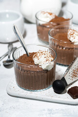 sweet chocolate mousse with whipped cream in glasses