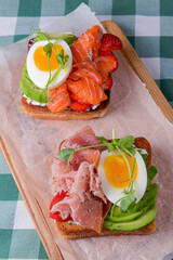 Smorrebrod, traditional Danish open sanwiches, dark rye bread with different toppings.