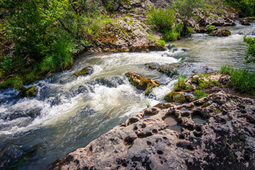 fast winding small mountain river flows among stones and gra © Coka