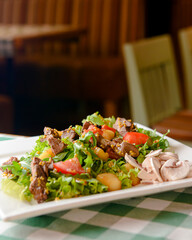 Salad with beef, tomatoes, fresh lettuce salad and arugula, raw mushrooms and great dressing from dijon mustard.