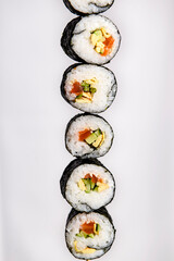 Maxi sushi, isolated on white background. Presented in vertical raw over white. Traditional Japanese cuisine concept