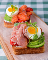 Smorrebrod, traditional Danish open sanwiches, dark rye bread with different toppings.