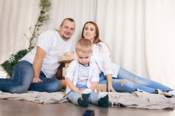 Close up little boy suffering from parents conflict sitting at couch. Sad son frustrating hear mother and father fighting arguing and bad situation, family conflict, divorce.