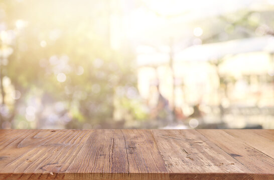 background Image of wooden table in front of abstract blurred restaurant