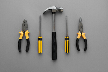 Flat lay composition with construction and home repair tools tools on grey background, space for...
