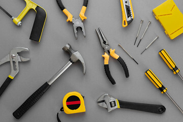 Flat lay composition with construction and home repair tools tools on grey background, space for...