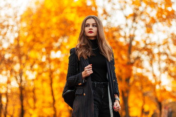 Beautiful molded fashionable girl with red lips in a fashion clothes with a blazer and a sweater...