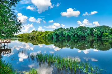 Beautiful natural scenery of river. Panoramic view of valley of river lake. Peaceful summer landscape with green hills, beautiful woods, meadows, river