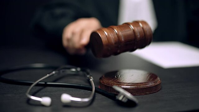 Judge striking gavel in health court, punishment for medical malpractice