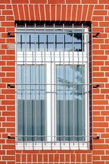 Lattice window built into an orange brick wall