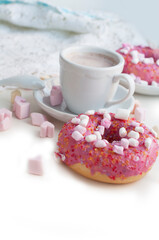 Romantic breakfast with pink donuts, cocoa and pink marshmallows in the shape of heart on white background. Breakfast for Valentines Day