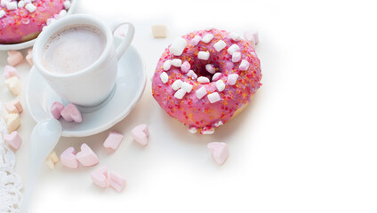 Romantic breakfast with pink donuts, cocoa and pink marshmallows in the shape of heart on white background. Breakfast for Valentines Day