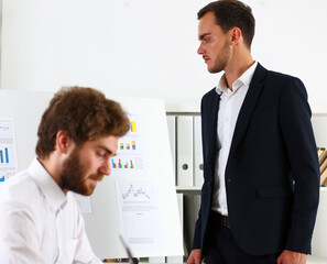 Group of people deliberate on white board problem
