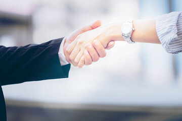 Handshake partnership deal meeting concept. Successful businessmen handshaking after good deal. Happy people shaking hands. Worker Hand Assemble Corporate Meeting Teamwork Concept. blurred background