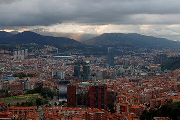 Fototapeta na wymiar Evening over the city of Bilbao in a cloudy day
