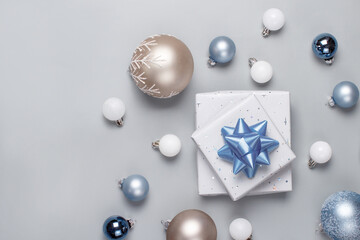 Christmas present and decorations top view on grey