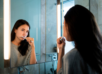 Woman brushing her teeth in the morning