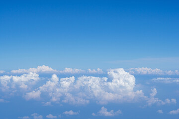 Aerial view of clouds and sky as seen through the window of an aircraft