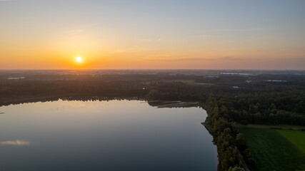 Beautiful, colorful sky over a lake at sunset. Peaceful scene, no one in sight. . High quality photo