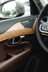 Fototapeta premium Car interior detail. Closeup of controls on the door