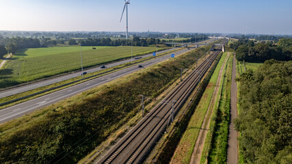 Fototapeta na wymiar Motorway with few cars and railroad next to it, near the exit of Brecht in Belgium, Europe. High quality photo
