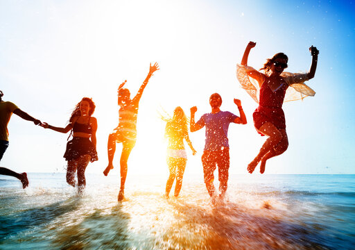 Friends playing in the water at the beach