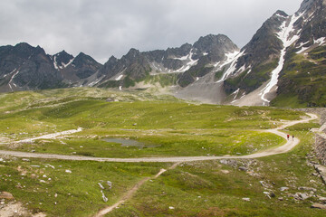 Panoramic view of pathway in the high Val Formazza during cloudy day of july in the Piedmont alps, Italy