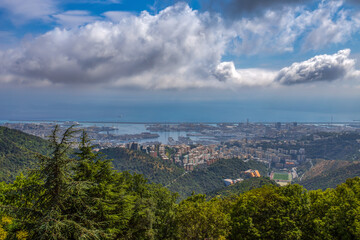 Aerial view of the city of Genoa under a cloudy sky, Italy.