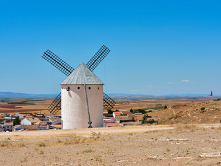 The windmills of Campo de Criptana, located in Castile-La Mancha, on a sunny day in summer. The mills are located in the so-called "Sierra de los Molinos"
