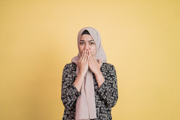 Muslim woman with shocked facial expression gesture covering mouth