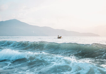Azure wave in the ocean. Asian fishing boat in the sea in Vietnam.