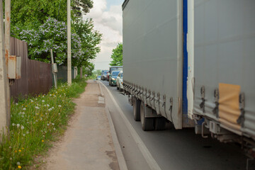 Traffic jam. Freight transport is stuck in a traffic jam on a narrow road.