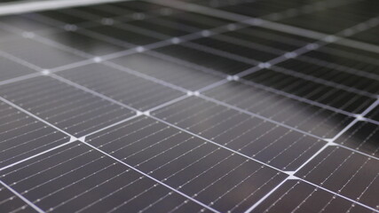 Photovoltaic solar panel extreme close up. Close-up of modern photovoltaic solar battery panels. Rows of sustainable energy solar panels installed on terrace. Solar panels on roof top. Panels at home.