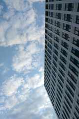 Fototapeta na wymiar The wall of a modern building against a blue sky.