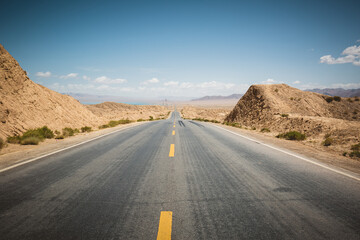 Trail in desert under blue sky