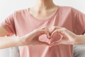 Woman making hands in heart shape, Love, heart health insurance, social responsibility, donation, happy charity volunteer, world heart day, appreciate, world mental health, cancer day