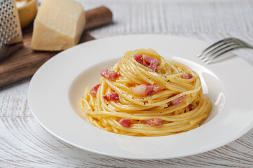 Spaghetti carbonara in a white plate. Pasta, pancetta and sauce made of egg yolk and parmesan...