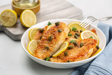 Chicken breast dredged in flour and cooked in sauce cantaining lemon juice, butter and capers....