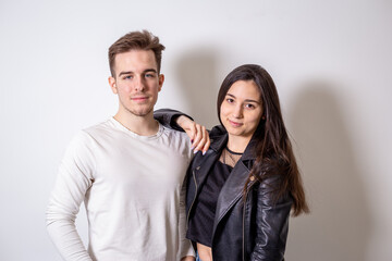 Portrait of young couple in front of white background