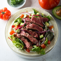 Beef steak fajitas with avocado and onion